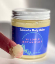Load image into Gallery viewer, glass jar of lavender body balm and image of thick balm on the end of a finger